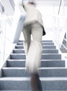 Businessman Running Up Stairs --- Image by © Royalty-Free/Corbis