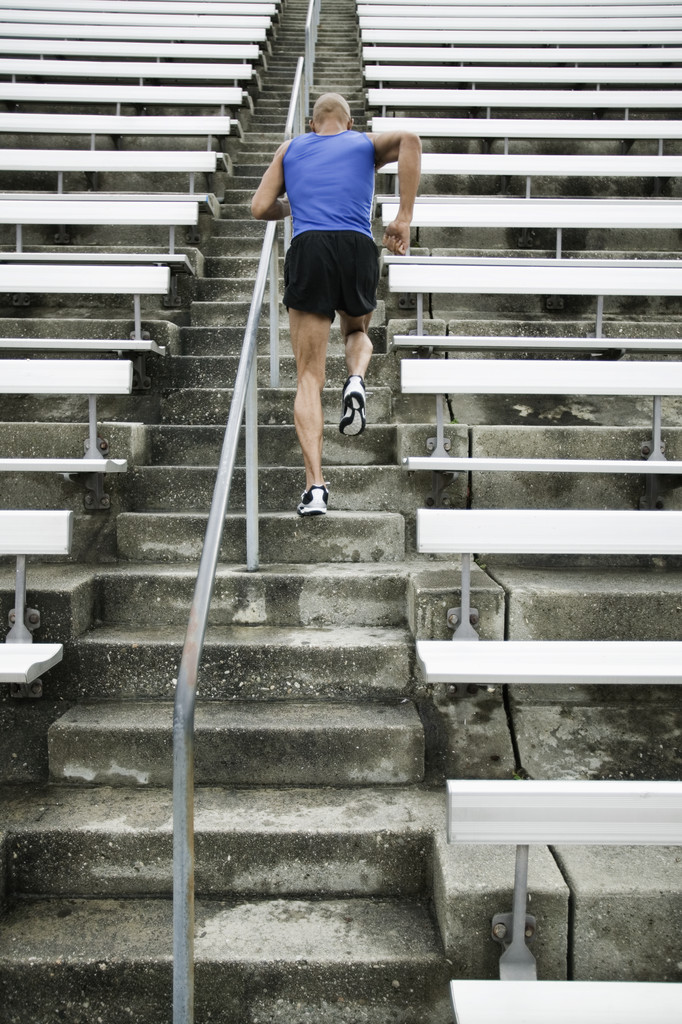 Back View of Man Running on Stairs